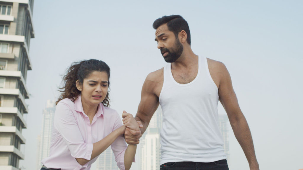 scared girl holding hand of a guy in vest